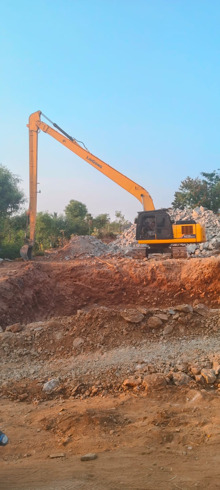 Construction workers building well wall with concrete rings